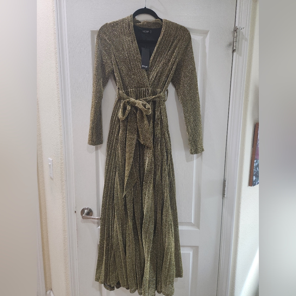 New with tag gorgeous gold long gown. Pleated skirt